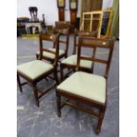 A SET OF FOUR GEORGE IV MAHOGANY DINING CHAIRS WITH REEDED BACK UPRIGHTS AND RAILS, DROP IN SEATS ON