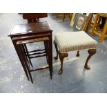 A CARVED WALNUT STOOL IN THE GEORGIAN TASTE TOGETHER WITH A NEST OF THREE MAHOGANY TABLES.