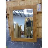 A LARGE OAK RUSTIC FRAMED WALL MIRROR WITH BEVELLED PLATE. 119 X 158cms.