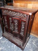 AN ORIENTAL HARDWOOD LOW FOUR DOOR CABINET. W 69 X D 33 X H 78cms.