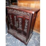 AN ORIENTAL HARDWOOD LOW FOUR DOOR CABINET. W 69 X D 33 X H 78cms.