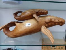 A CARVED WOODEN SCULPTURE OF A WHALE AND A CALF.