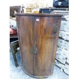 A GEORGE III MAHOGANY BOW FRONT CORNER CABINET.