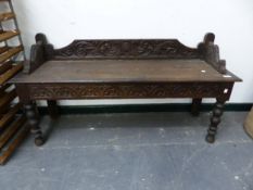 A CARVED OAK HALL BENCH. W 122 X D 37 X SEAT HEIGHT 45CMS.