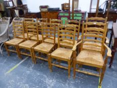 A SET OF TEN RUSH SEAT ELM LANCASHIRE LADDER BACK DINING CHAIRS, INC TWO CARVERS.