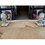 A PAIR OF LARGE SEATED LION FIGURES.