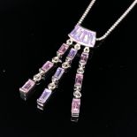 A SILVER AND STONE SET ARTICULATING PENDANT WITH PINK AND PURPLE FACETED STONES SUSPENDED ON A