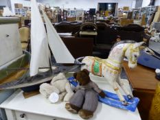 A VINTAGE STYLE MODEL BOAT, A MINIATURE ROCKING HORSE, AND TWO CUDDLY TOYS.