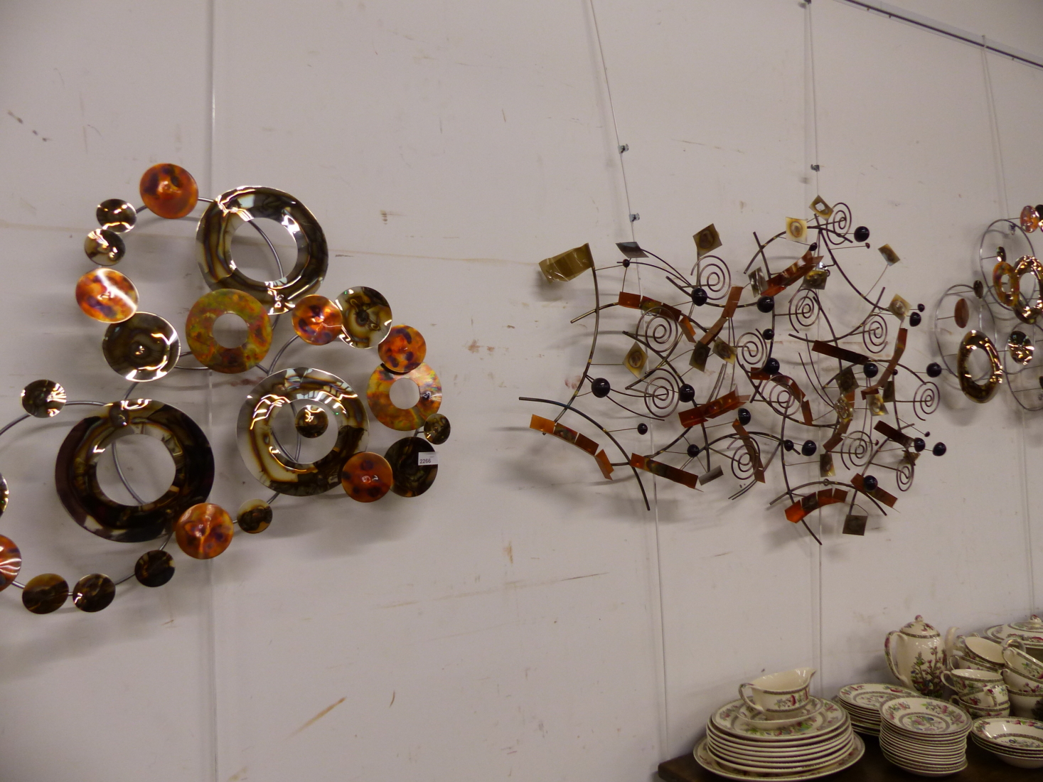A GROUP OF THREE METAL WALL SCULPTURES.