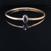 A CHILDS VINTAGE STONE SET BANGLE, INDISTINCTLY SIGNED POSSIBLY SP.