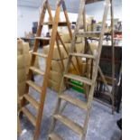 TWO LARGE ORNAMENTAL STEP LADDERS.