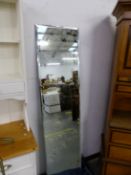 A LARGE BEVEL PLATE UNFRAMED MIRROR.