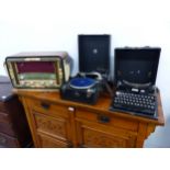 A VINTAGE REMINGTON COMPACT PORTABLE TYPEWRITER, A PORTABLE GRAMOPHONE, AND A A 1950'S VALVE RADIO.