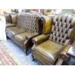 A BUTTON LEATHER UPHOLSTERED WING BACK THREE PIECE SUITE.