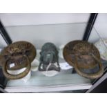 THREE ORIENTAL BRASS MASK HANDLES.