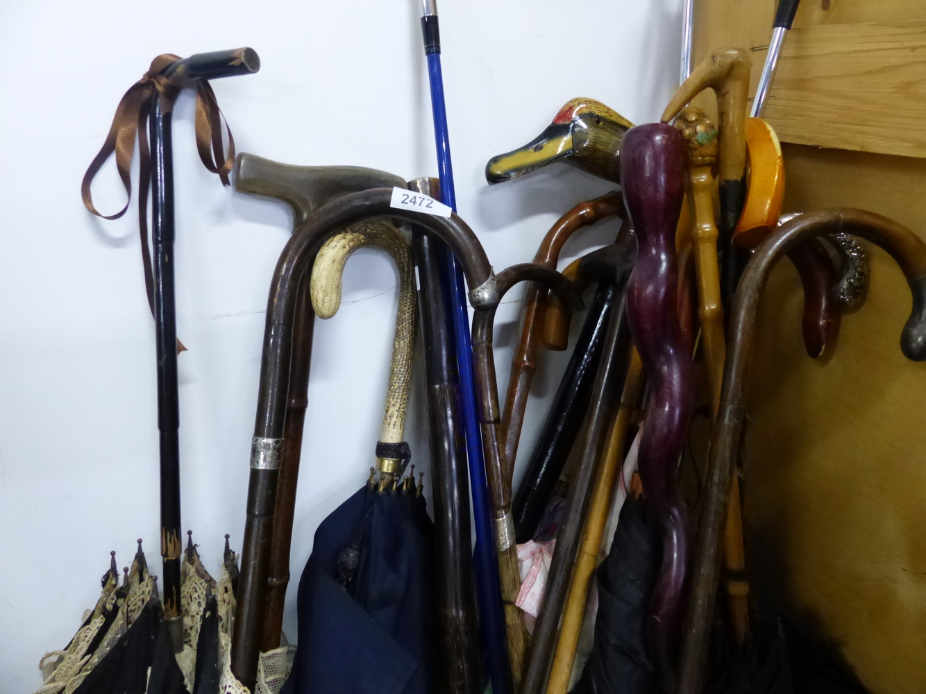 A LARGE QUANTITY OF WALKING STICKS, UMBRELLAS ETC INC. SOME ANTIQUE SILVER MOUNTED EXAMPLES.