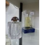 AN ART DECO CUT GLASS SCENT ATOMISER AND A BOXED CARTIER PERFUME.