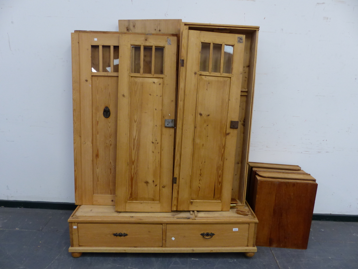 AN ANTIQUE CONTINENTAL PINE KNOCK DOWN WARDROBE WITH TWO DRAWER BASE. W143 X D 59CMS.