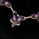 SILVER AND AMETHYST MIXED CUT NECKLACE. FIVE FACETED AMETHYSTS IN RUBOVER SETTINGS SUSPENDED ON A