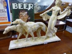 AN ART DECO STYLE PLASTER FIGURE GROUP OF GIRL WITH TWO SALUKI DOGS.