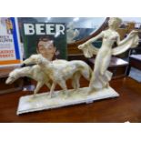 AN ART DECO STYLE PLASTER FIGURE GROUP OF GIRL WITH TWO SALUKI DOGS.