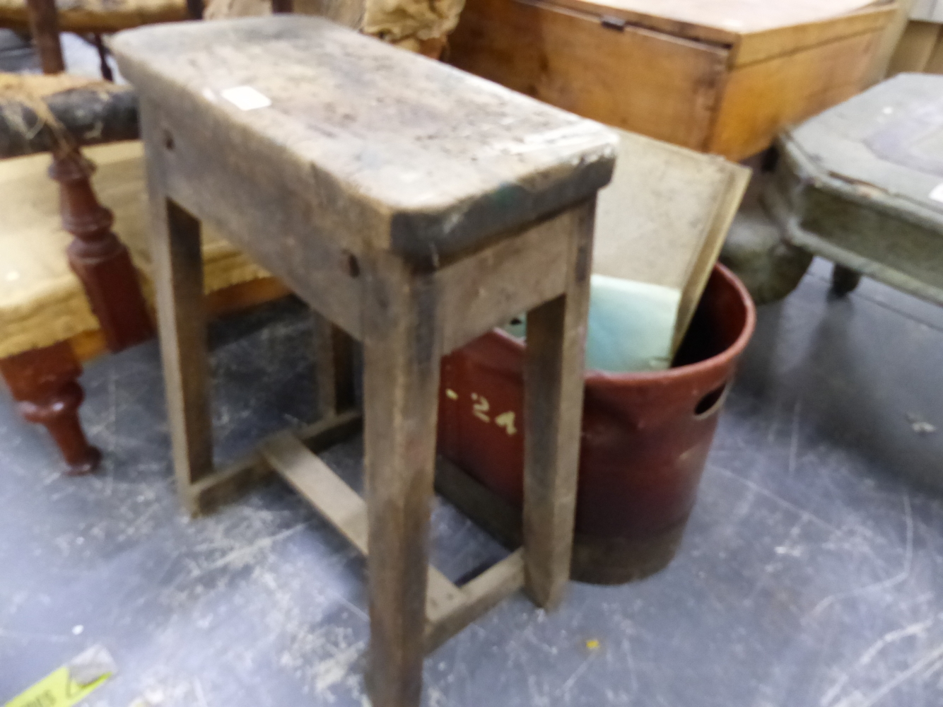 A RUSTIC STOOL AND TWO HANDLED RIVETED BUCKET.