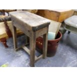 A RUSTIC STOOL AND TWO HANDLED RIVETED BUCKET.
