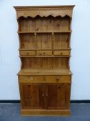 A SMALL MODERN PINE DRESSER AND PLATE RACK. W 98 X D 37 X 194CMS.