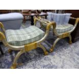 A PAIR OF SILVER AND GILT DECORATED X FORM STOOLS.