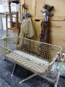 A VICTORIAN FOLDING ROCKING CRADLE AND TWO BAGS OF IRON SHAFT GOLF CLUBS.