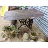 A SLATE TOP IRON BASE GARDEN TABLE.