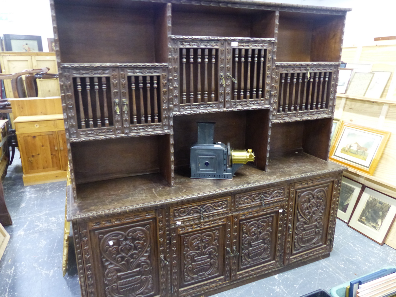 A CARVED HARDWOOD SIDE CABINET WITH RAISED RACK OVER. W 195 X D 46 X H 191CMS.