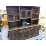 A CARVED HARDWOOD SIDE CABINET WITH RAISED RACK OVER. W 195 X D 46 X H 191CMS.