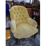 A VICTORIAN BUTTON BACK ARMCHAIR ON CARVED FORELEGS.