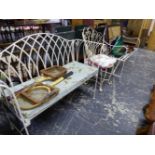 A WROUGHT IRON REGENCY STYLE GARDEN SEAT, ANOTHER GARDEN BENCH WITH A SQUAB CUSHION, AND A
