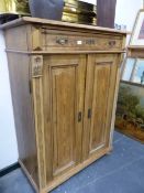 A CONTINENTAL ANTIQUE PINE TALL SIDE CABINET. W 101 X D 52 X H 134CMS.