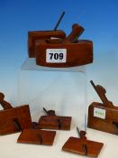 SEVEN MINIATURE WOOD PLANES TO INCLUDE ONE BY BUCH, THE OTHERS WITH OWNERS NAMES AND INITIALS