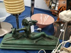 AN ART DECO GREEN PLASTER TABLE LAMP, A LADY RECLINING ON THE BASE WITH HER ALSATIAN DOG, THE