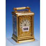 A CARRIAGE CLOCK IN GLAZED BEADED CASE STRIKING AND REPEATING ON A COILED ROD, THE DIAL WITH