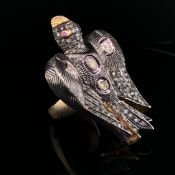 A POLKI DIAMOND SET LARGE BIRD RING, THE LARGE CARVED BIRD IN SILVER WITH A SILVER GILT SHANK.