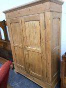 A CONTINENTAL PINE KNOCK DOWN TWO DOOR WARDROBE. W. 139 x D. 52 x H. 205cms.