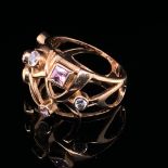 A RUSSIAN HALLMARKED ROSE GOLD GEM SET RING TESTED AS 14ct GOLD. SET WITH EIGHT RUB OVER SET PINK,