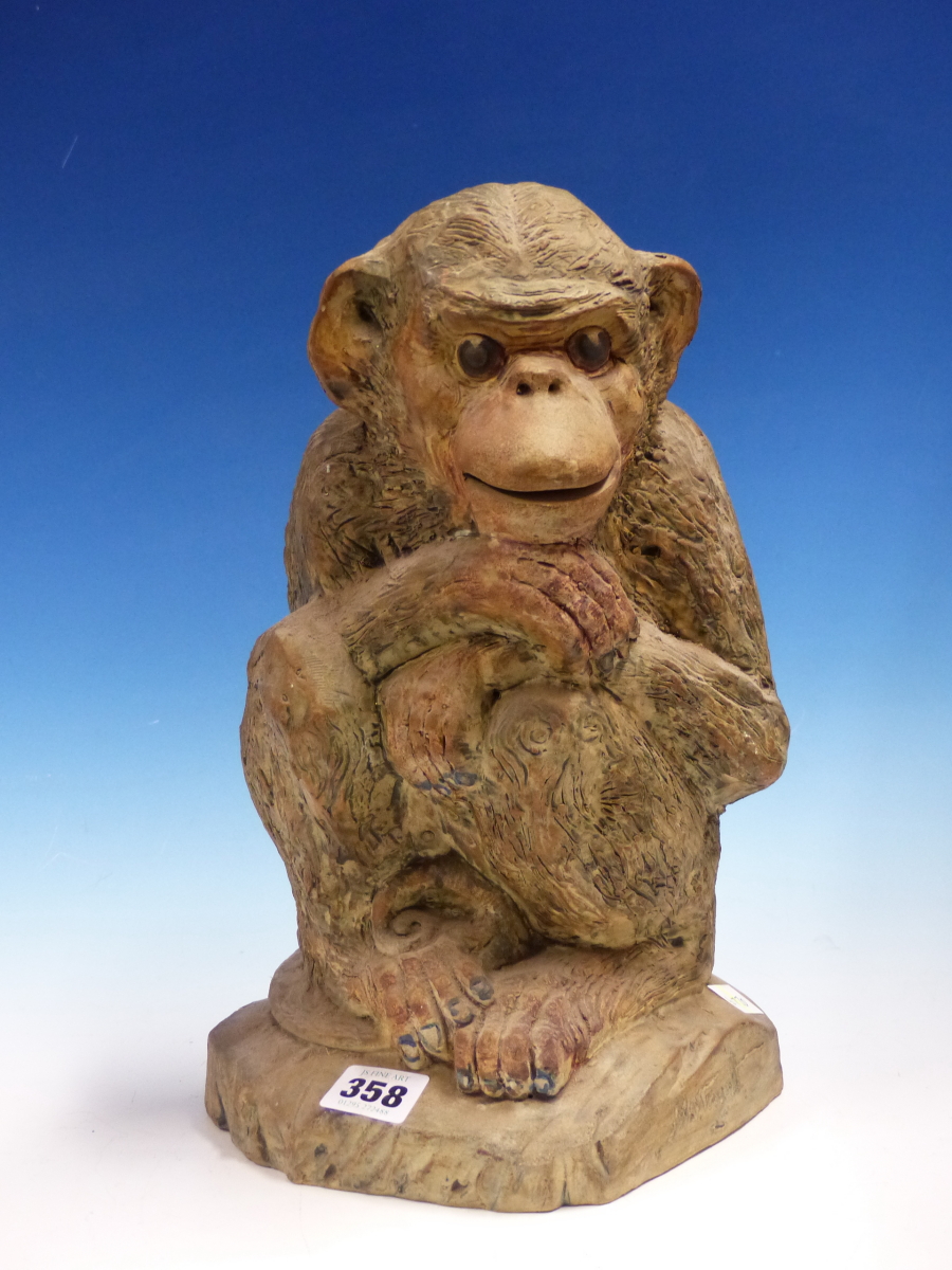 A STUDIO POTTERY FIGURE OF A SEATED MONKEY, THE OATMEAL CLAY TINTED IN COLOURS, INDISTINCTLY SIGNED.
