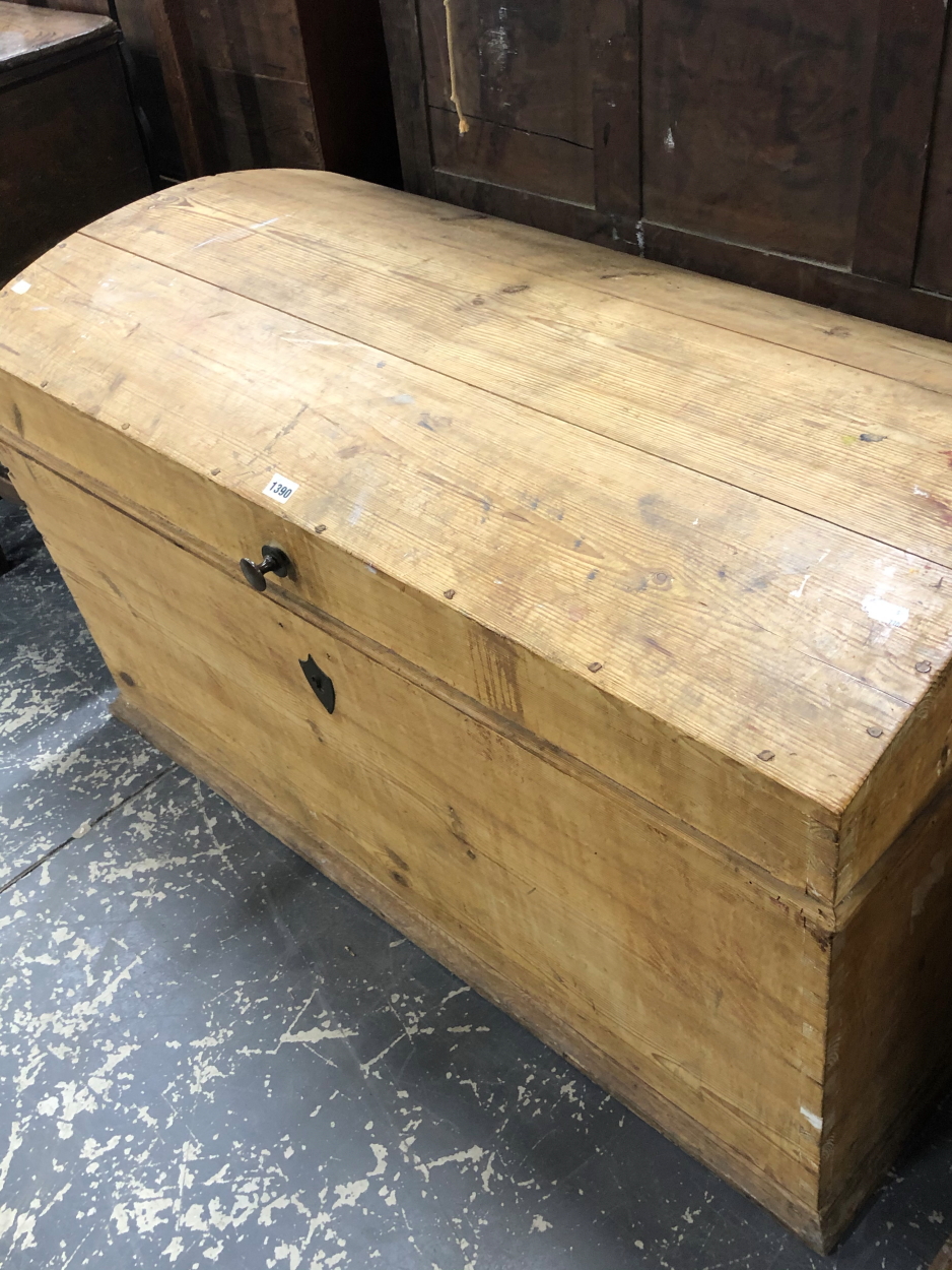 A PINE ROUND ARCH LIDDED TRUNK, THE RECTANGULAR SIDES TAPERING TO A PLINTH FOOT. W 116cms - Image 2 of 2