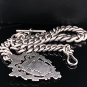 AN ANTIQUE SOLID SILVER LARGE GRADUATED WATCH ALBERT COMPLETE WITH T BAR AND SHIELD FOB. CHAIN DATED