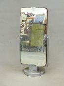 AN ART DECO CHROME BASED DOUBLE SIDED SWING MIRROR. H. 77cms.