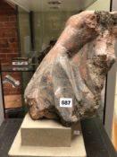 A PINK MOTTLED GREY HARDSTONE CARVING OF A WOMAN'S TORSO, MOUNTED ON A TWO STEPPED GREY STONE PLINTH