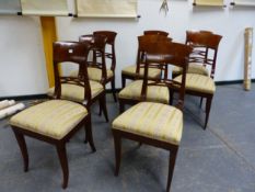 A SET OF EIGHT BIEDERMEIER MAHOGANY DINING CHAIRS, THE BROAD TOP RAILS OVER CRUCIFORM BARS,