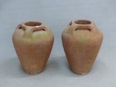 ATTRIBUTED TO THE COMPTON POTTERY, A PAIR OF TERRACOTTA OVOID VASES, EACH WITH FOUR HANDLES