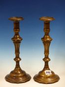 A PAIR OF BRONZE CANDLESTICKS WITH OCTAGONAL NOZZLES AND BALUSTER STEMS. H 29.5cms.